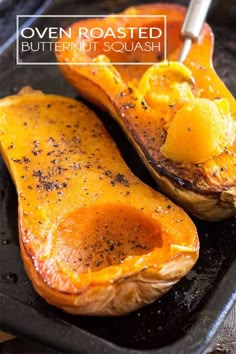 two roasted butternut squash on a baking sheet with the title text overlay reads oven roasted butternut squash