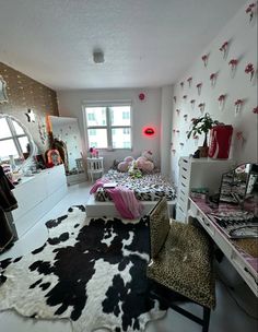 the bedroom is decorated in pink, black and white with leopard print rugs on the floor