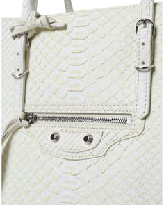 Made of 100% Pythonskin Leather Color: White Dual rolled slim handles Front zip pocket Silver-tone hardware Classic studs and buckle details Balenciaga logo details on the front Made in Italy Dimensions: 31cm x 41.5cm x 18cm Material: 100% Pythonskin Leather Luxury Bags With Silver-tone Hardware, Luxury White Bags With Silver-tone Hardware, Yellow Balenciaga, Balenciaga Tote Bag, Balenciaga Tote, Python Skin, Balenciaga Logo, Lemon Yellow, Leather Tote Bag