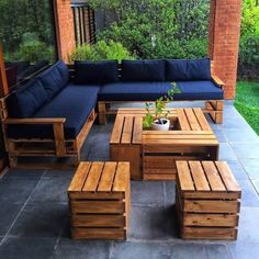 an outdoor patio with wooden furniture and plants