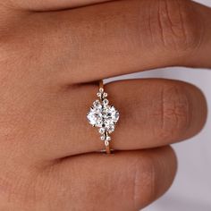 a woman's hand with a diamond ring on it