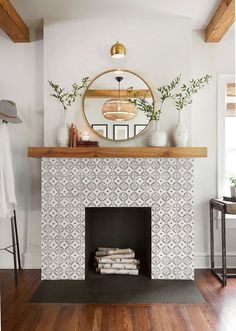 a white fireplace with a mirror above it