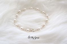 "Elegant white pearl bracelet delicately hand wrapped to form a handmade chain. Made with genuine Swarovski white pearls (5mm). This dainty bracelet is perfect for weddings or everyday occasion. It is also the birthstone for June. CHOOSE YOUR PEARL COLOR (see photo #7) 1) White - as pictured 2) Pearlescent white - iridescent shimmer 3) Cream  CHOOSE TYPE OF FINISH: 1) Sterling silver - made with sterling silver wire and sterling silver spring clasp 2) Silver plated - made with silver plated wire Elegant Wire Wrapped Pearl Bracelet, Minimalist Sterling Silver Pearl Bracelet With Charm, Elegant White Wire Wrapped Pearl Bracelet, Minimalist Sterling Silver Pearl Bracelet For Wedding, Minimalist Sterling Silver Pearl Chain Bracelet, Wedding Sterling Silver Pearl Drop Bracelet, Dainty Sterling Silver Pearl Bracelet With Charm, Dainty Sterling Silver Pearl Drop Bracelet, Pearl White Sterling Silver Bracelet With Pearl Charm