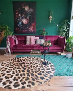 a living room with green walls and leopard print rug