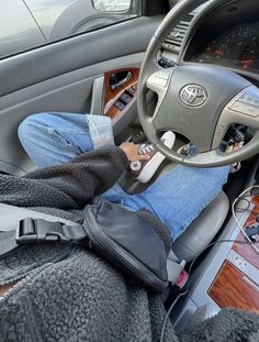 a person sitting in the driver's seat of a car