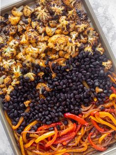 a pan filled with black beans, carrots and cauliflower