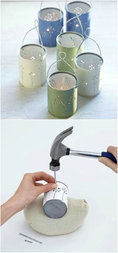 some tin cans are being filled with paint and a hand is using a hammer to fix them