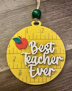 a wooden ornament with the words best teacher ever on it