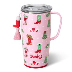 a pink cup with christmas decorations and boots on it, the mug has a tassell