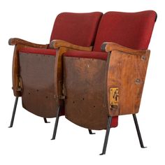 two chairs sitting side by side with red upholstered seats on the back and arms