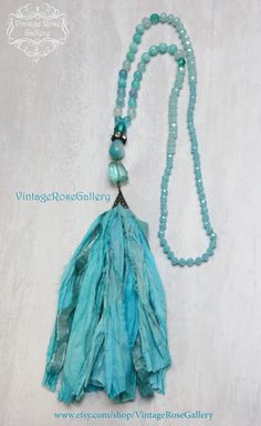 "Sari Silk Tassel Necklace, Aqua Silk Tassel Necklace, Turquoise Agate Jade Boho Chic Necklace, Statement Necklace ''Mermaid Necklaces \" A gorgeous hand made Sari silk tassel Turquoise Necklace . Features antique rhinestones, beautiful light blue Agate gemstones 8mm , a large Aqua Quartz , a large jade gemstone, antique copper findings , Czech glass and a beautiful hand made Sari Turquoise Silk tassel This necklace is so beautiful ... It is full of Aqua colours The Agate gemstones have a gradua Silk Tassel Necklace, Boho Chic Necklace, Chic Necklace, Turquoise Boho, Necklace Turquoise, Mermaid Necklace, Sari Silk, Necklace Statement, Aqua Color