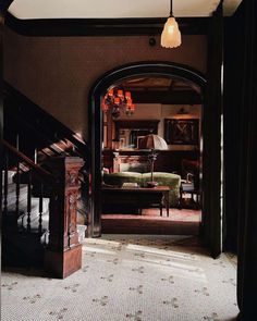 an open doorway leading to a living room with furniture and decor on the walls in front of it