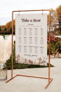 Brown retro/ boho style wildflower print wedding table plan. Shown hanging in a copper frame Wedding Find Your Seat Ideas, Hanging Seating Chart, Hanging Seating, Ice Wedding, Wildflower Design, Pvc Board, Seating Plan Wedding