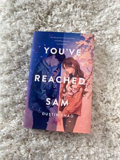 the book you've reached sam by dustin thaao is laying on a white carpet