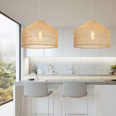 two white stools in front of a kitchen island