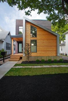 a modern home with wood siding and windows