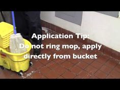 a person is cleaning the floor with a mop and bucket on top of it