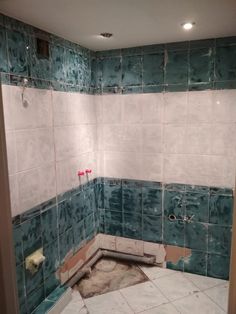 a bathroom that is being remodeled with blue and white tiles on the walls, floor and wall