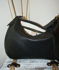 Handmade black leather medium size hobo bag with depth. The bag is closed with a metallic zip. Inside is unlined and there is a large cotton zipped pocket. The bag has an adjustable shoulder strap made with stronger black leather. To add an extra touch to the bag you can buy the short handle which measures 18 inch in length and is made with beautiful black leather. This medium size hobo bag is a perfect bag for every moment Features : - Black leather, - Black leather strap, - Zipped bag, - Unlin Black Leather Lined Hobo Bag For Everyday Use, Black Hobo Bag With Leather Lining For Everyday Use, Black Leather Hobo Satchel, Leather Hobo Bag With Zipper Closure, Black Hobo Satchel With Leather Handles, Black Hobo Bag With Zipper Pocket For Everyday, Black Soft Leather Hobo Satchel, Black Hobo Bag With Leather Lining, Modern Black Hobo Bag With Zipper Pocket