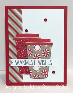 a close up of a cup of coffee on a card with candy canes in it