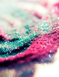 a close up view of a red and green piece of cloth with water droplets on it