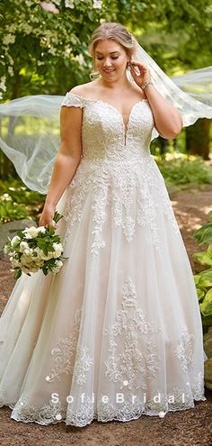 a woman in a wedding dress is posing for the camera