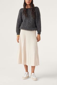 Lightweight, flowing, and designed with figure-enhancing pleats...this JADA knit midi skirt is impossible to resist! Perfect for the fall and the first cold days of winter, this skirt can be worn high or low on your wais - depending on the desired look. Feel free to pair it with the matching JYNX sweater. This item is made with wool derived from a certified production chain guaranteeing the welfare of animals and the sustainable management of pastures - Midi skirt- Flowing Sustainable Management, Skirt And Sneakers, Knit Midi Skirt, Black Midi Skirt, Pump Dress, Knit Midi, Animal Welfare, Long Sleeves Jacket, Dress Pant