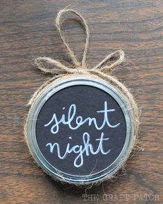 a mason jar with the words silent night written on it, tied to a rope