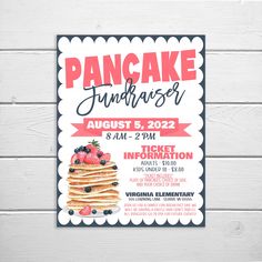 a pancake fundraiser flyer is shown on a white wooden background with red and black lettering