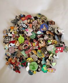 a pile of buttons sitting on top of a white sheet covered in lots of them