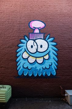 graffiti on the side of a building depicting a cartoon character with a hair dryer