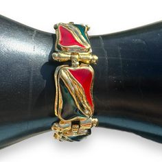 This is an IVANA signed ruby red and emerald green enamel organic design stations bracelet in a shiny gold tone cast metal alloy. Signed: IVANA© on the back.  Measures - 8" Weight - 1.4 ounces Pics are part of our description. Please view the ENTIRE listing carefully as we don't offer returns. If you have any questions, please ask us BEFORE purchasing. We're happy to answer you.  Located at MyStyle Boutique. Open Mon-Sat 10-5 at 11000 70th Ave. Seminole, FL 33772 CLOSET TAGS: vintage jewelry, vi Retro Enamel Jewelry For Party, Red Metal Costume Jewelry Bracelets, Retro Enamel Bracelets For Gifts, Retro Enamel Bracelets For Gift, Red Metal Costume Jewelry Bracelet, Retro Enamel Bracelet For Gift, Retro Enamel Party Jewelry, Fashion 1990s, Fashion 2000s