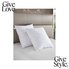 two pillows on top of a bed with the words give love