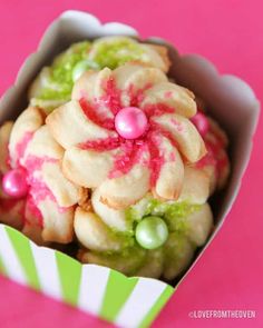 a box filled with cookies on top of a pink table