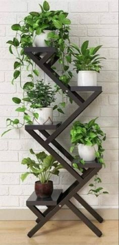 three tiered plant stand with potted plants on it