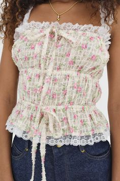 Embrace a laid-back summer with the Amelia pink top - a floral blouse with an allover wild rose print, ruched tiers, and ruffled lace trims throughout. It's crafted in a lurex fabric with a subtle luster that catches the light - pair it with your favorite vintage cut-offs for an effortless summer look. - Square neck. - Lace trim shoulder straps. - Decorative skinny tie bows at the neckline and waist. - Elasticized tiers throughout the bodice. - Ruffled lace trims throughout. - Rose print throughout. - Relaxed fit. - Unlined. - Lurex fabric with a subtle luster. - Color: Pink. - Floral tulle. - Material: 100% Polyester. - Model is 5’9.5” (176 cm), Bust 32C (81 cm), Waist 24 (61 cm), Hips 34 (86 cm), and is wearing a size S. - When you are ready to dry clean, we suggest choosing an environme Lurex Fabric, Wild Rose, Summer Look, Pink Top, Cute Fits, For Love And Lemons, Rose Print, Preppy Outfits, Ulla Johnson