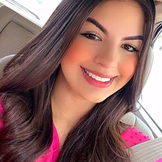 a woman sitting in the back seat of a car