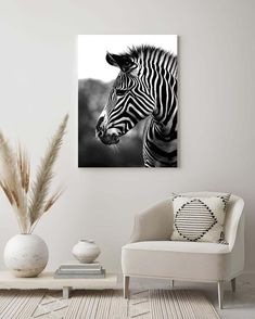 a black and white photo of a zebra's head on a wall in a living room