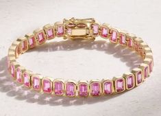 14K Gold pink sapphire emerald cut tennis bracelet / pink sapphire birthstone bracelet / everyday gemstone jewelry / best friend gift Birthstone Bracelet gift for her Metal: 925 Sterling Silver ( Yellow Gold Plated ) Metal Weight: Approx. 18 Grams Gemstone: Pink sapphire ( lab created ) Gemstone: Natural Pink Zircon Shape & Size: 6x4 mm Gem Weight: Approx. 10. CT Stone Cut : Excellent Stone Colors : Pink Standard Delivery : Under free delivery services parcel will be delivered 15 days from the d Fine Jewelry With Emerald-cut Pink Sapphire, Gold Jewelry With Multi-stone Pink Sapphire, Gold Multi-stone Jewelry With Pink Sapphire, Pink Sapphire Multi-stone Jewelry For Gifts, Pink Emerald-cut Tourmaline Jewelry, Sapphire Birthstone, Birthstone Bracelets, Jewelry Manufacturers, Wedding Jewelry Bracelets