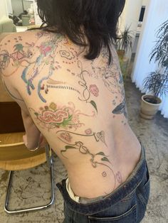 the back of a woman with tattoos on her body