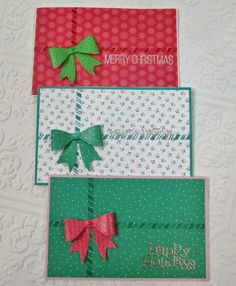 three folded christmas cards with bows on them