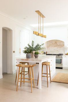 a kitchen with two stools and an island