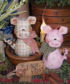 two stuffed animals sitting next to each other on top of a plaid cloth covered table