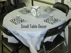 the table is set with black and white paper napkins on it's edges