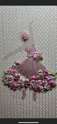 an embroidered dress with pink flowers on it