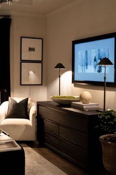 a living room filled with furniture and a flat screen tv mounted to the side of a wall