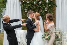 a bride and groom kissing in front of their guests