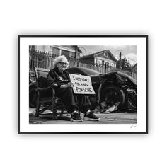 an old man sitting on a bench holding a sign