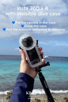 someone holding up their camera in front of the ocean with text that reads insta 360 x 4 with invisible dive case