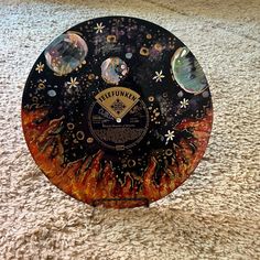 a black and orange frisbee sitting on top of a carpet